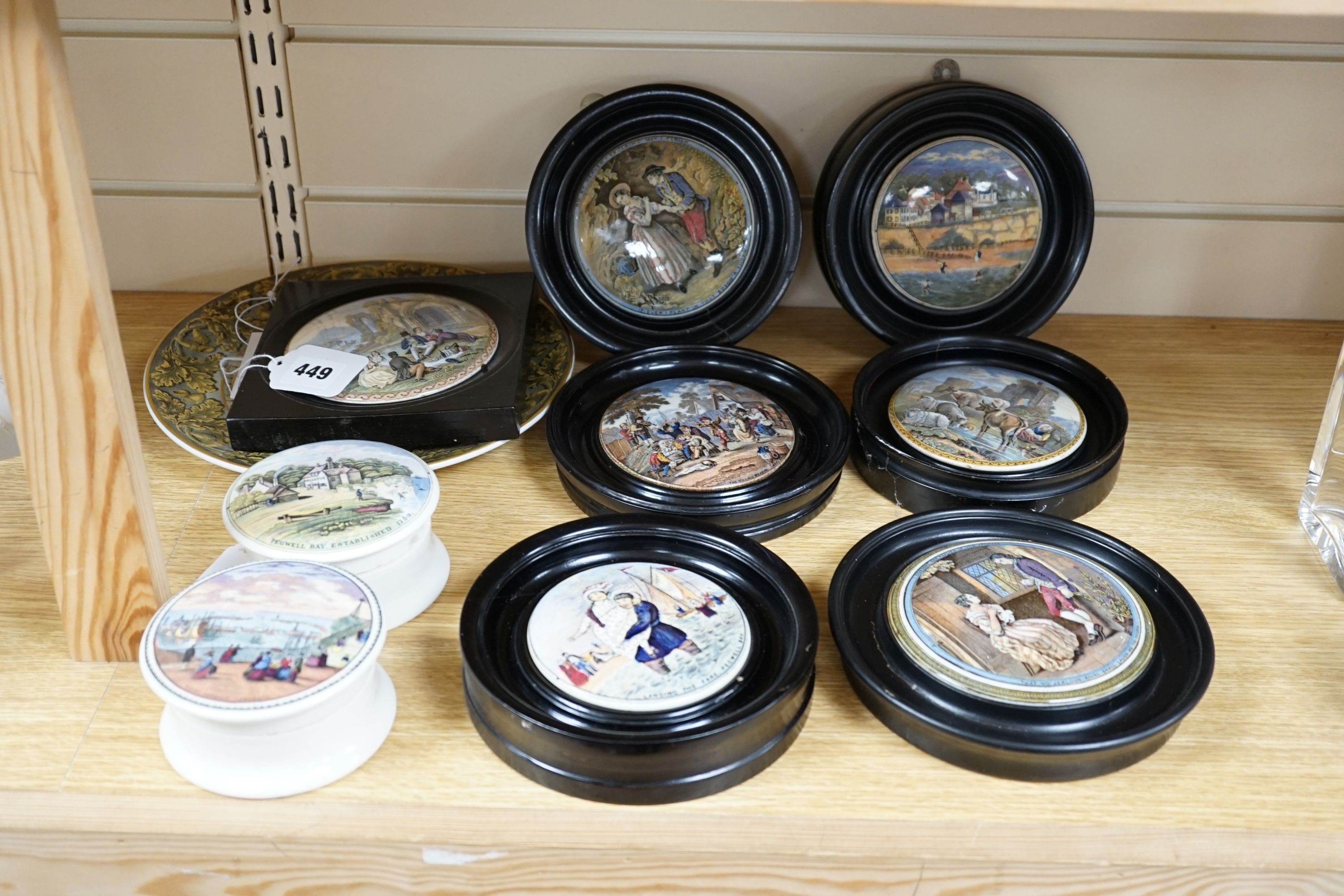 Seven Prattware pot lids, mounted in ebonised wood frames, an F & R Pratt plate and two pot lids with bases